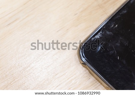 Close Up Smartphone With Broken Screen on Light Wooden Table