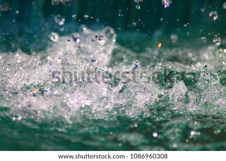 Swirling liquide background in marine green shades. Water splash.