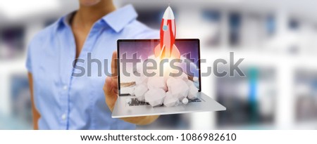 Businesswoman on blurred background with rocket launching from a laptop 3D rendering