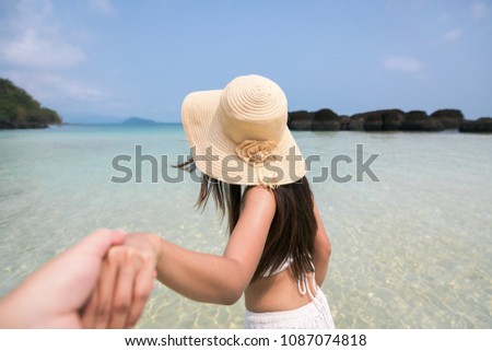 Summer woman vacations concept, Couple holding hands and walking on beach at day in Koh Mak, Thailand, Asia woman with white bikini and sunglass