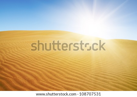 Gold desert under blue sky.