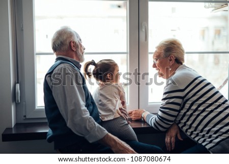 Young girl talking with her grandparents
