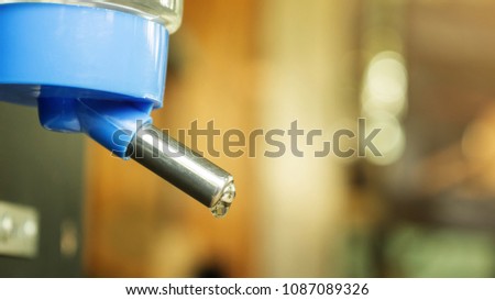 Close up of a water bottle with a dispenser for a pet.