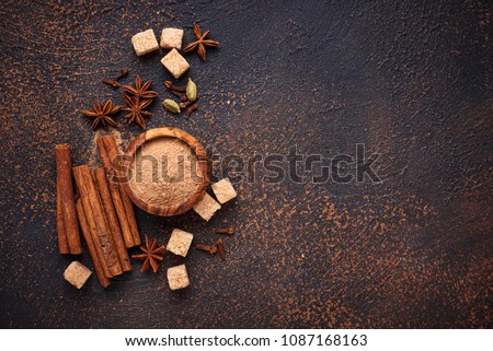 Winter spices cinnamon, anise, cardamom, clover and sugar Royalty-Free Stock Photo #1087168163