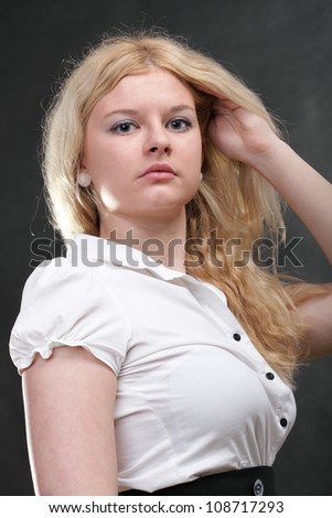 portrait of beautiful blonde woman grey background