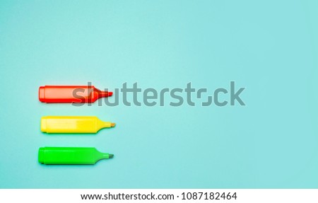 minimalism. three multicolored markers on a blue background. creativity, pin up, school stationery, school concept, space for text Royalty-Free Stock Photo #1087182464