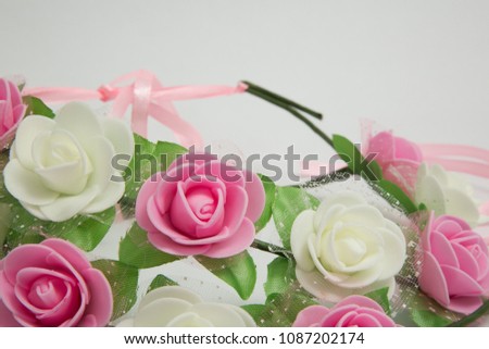 Shavuot flower crown accessories on white background. Plastic flowers isolated.