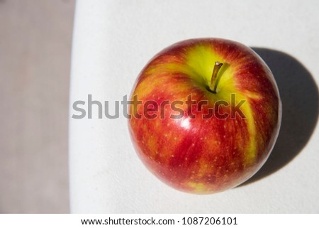 A bright color of an apple under the sun