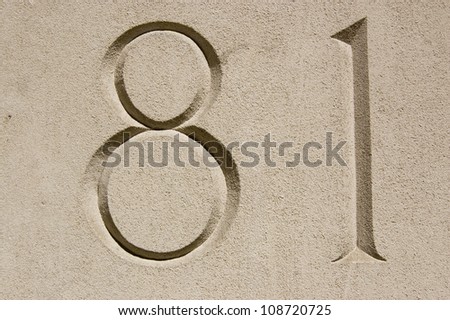 Number eighty one (81) carved into the outside wall of an office in London.