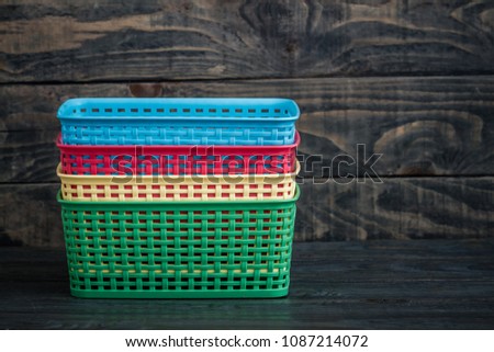 Colorful mini plastic cases on blue wooden background