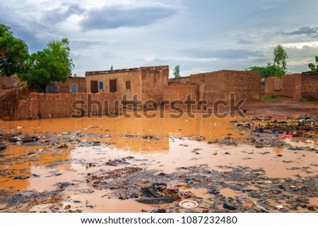 Flooded african slums with lots of garbage during the rainy season (july-august), Ouagadougou, Burkina Faso, West Africa. Royalty-Free Stock Photo #1087232480