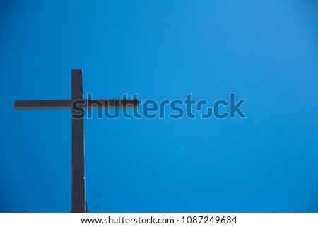 the old wooden cross with blue sky background.