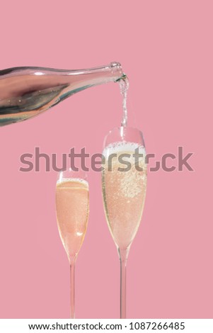 Valdobbiadene Prosecco flutes and a bottle, pink background, in pop contemporary style Royalty-Free Stock Photo #1087266485