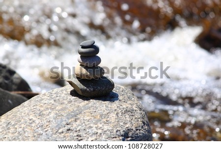 Stack of smooth round stones by a river