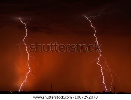 Lightning at Sunset - twins strikes of lightning during a Texas red dust sunset. 