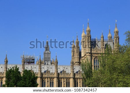 Image of British Parliament Building (Westminster) in London UK on a brilliant sunny day against a blue sky.