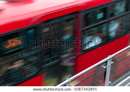 Red public bus in Bogota called Transmilenio at fast speeds. Bogota Colombia . Royalty-Free Stock Photo #1087343891