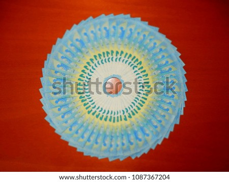 20 euro banknotes arranged in a circle on the desk to form a wheel with colorful foliage