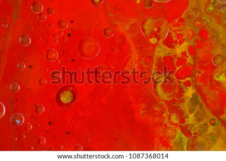 Colorful bright paint background. red paint with yellow smudges background. abstract  background with stains of paint. 	
