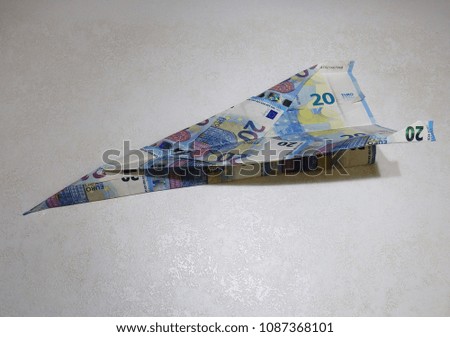 Banknotes of 20 euro together and bent to form a plane 