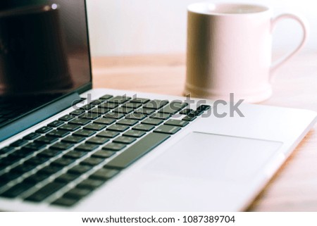 Laptop ,notebook ,pen and coffee on wood table