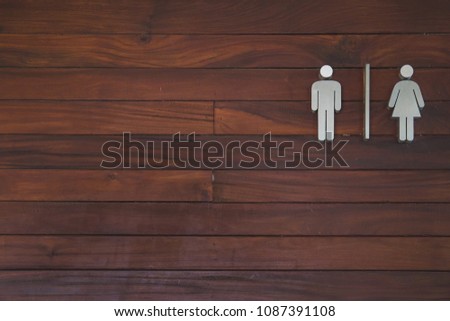 Sign toilet on wood background. Male and female.