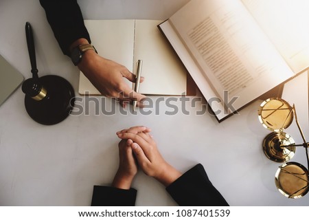 lawsuit and justice concept. judge discussion  defendant punishment   law in courtroom wich lawyer books and gravel. Royalty-Free Stock Photo #1087401539