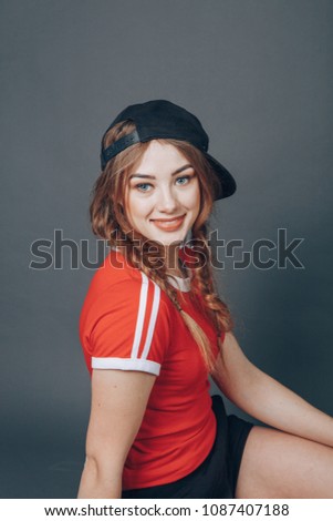 beautiful girl in the studio posing for photographer wearing workout clothes