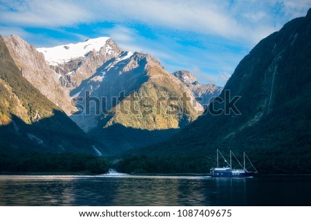 Mountain and glacier view from the Cruise Boat at Harrison Cove in Milford Sound, Fiordland National Park, New Zealand. The photo is illustrating also the melting of the glacier taking place.