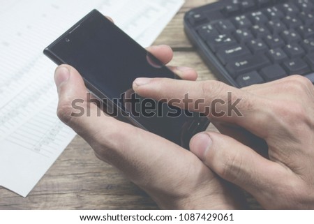 Business image - a businessman using a smartphone