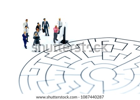Miniature people : Businessman work as teamwork help to solve problems on maze,Business concept.