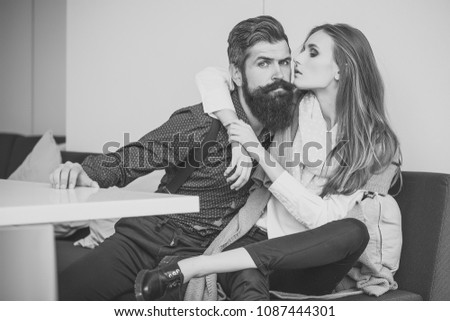 One beautiful stylish emotional couple of young woman and senior man with long black beard embracing sitting close to each other intdoor in cafe, horizontal picture