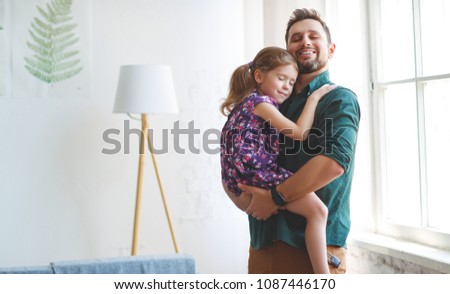 Father's day. Happy family daughter hugs his dad  on holiday

