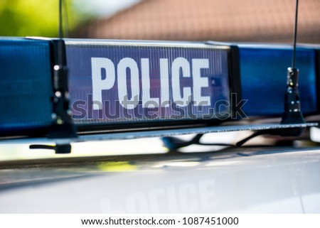 Police vehicle sign with blue lights.