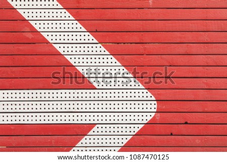 Arrow on a red wooden wall