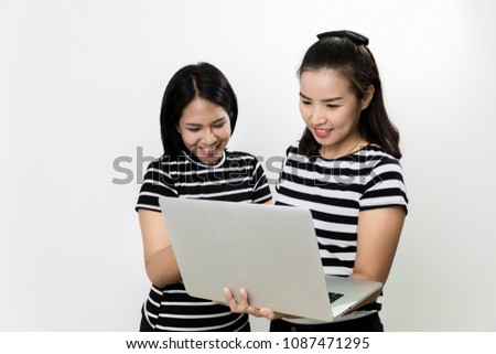 Portrait two young woman shopping online on laptop with happy and joyful isolated on white background