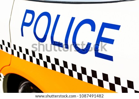 Police sign on the side of a patrol car.