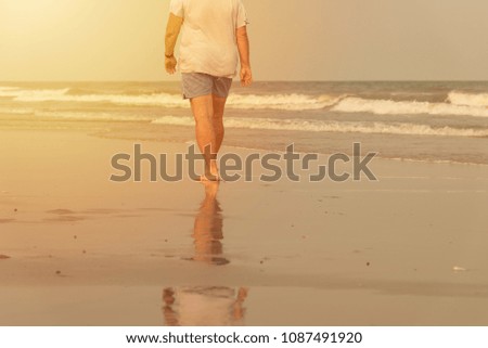 Man walking alone on the beach. beach travel at summer time concept