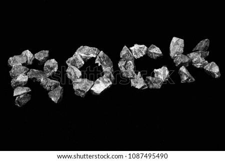 Rock word rock alphabet on black background. (black&white picture)