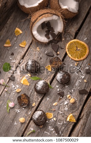 Chocolate Candies & Handmade Truffles. Hazelnut, dried apricot, coconut, chocolate. Fitness sweets Useful candys on wooden boards.