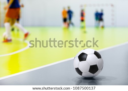 Futsal Background. Indoor Soccer Futsal Ball. Indoor Soccer Match in the Background. Futsal Sports Hall and Futsal Field. Youth Indoor Soccer League.  Royalty-Free Stock Photo #1087500137