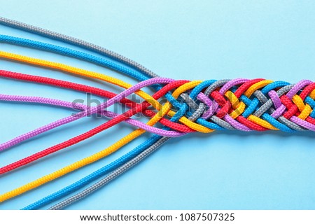 Braided ropes on color background, top view. Unity concept Royalty-Free Stock Photo #1087507325