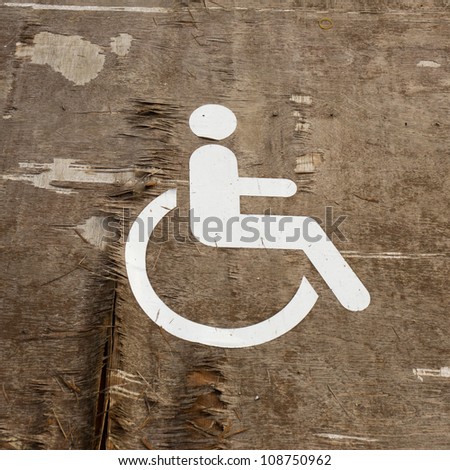 handicapped sign on old cracked wood background