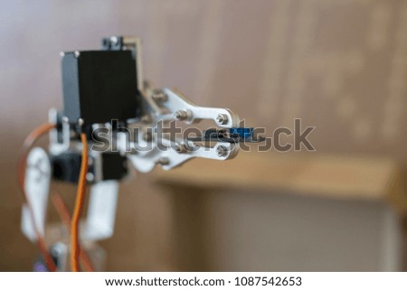Photo of robot manipulator, which holds the little chip