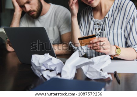 cropped shot of young couple counting bills together Royalty-Free Stock Photo #1087579256