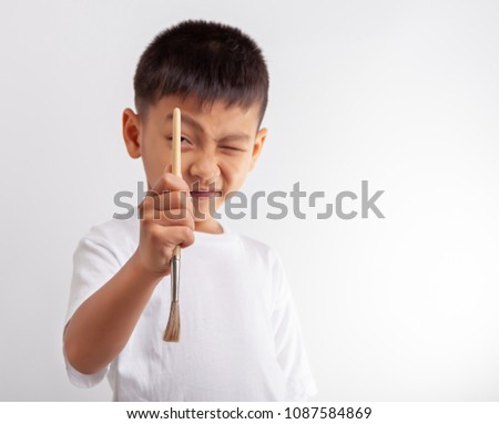 little boy with brush on white background.