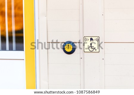 button at the entrance as help for disabled on wheelchair and invalids