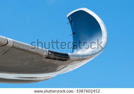 Wing and winglets close up flying in the sky Royalty-Free Stock Photo #1087602452