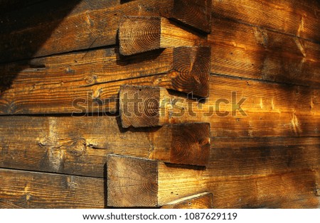 Some old elements of the wall of wooden church or log cabin in  daylight, Traditional Romanian or Ukrainian sacral folk architecture in province. Folklore art. Gradient color. Woodcraft in village. 