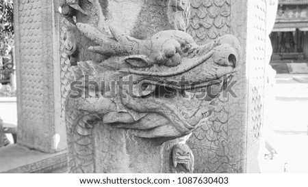 Statue of dragon made of stone in China. This image was blurred or selective focus. Black and white picture.